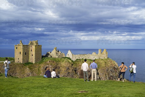 Tourists looking at Dunnottar Castle