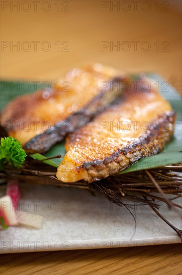 Japanese style teppanyaki roasted cod fish on palm leaf