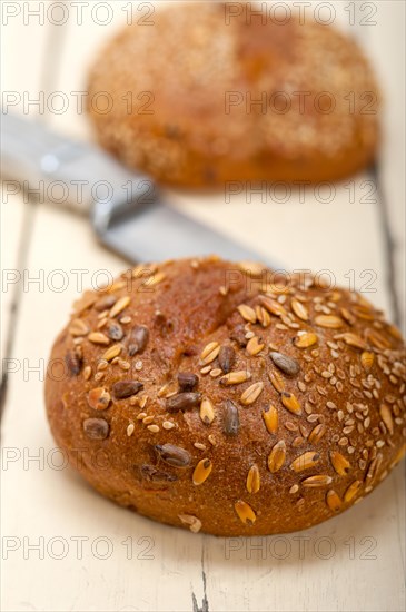 Fresh organic bread over rustic table macro closeup