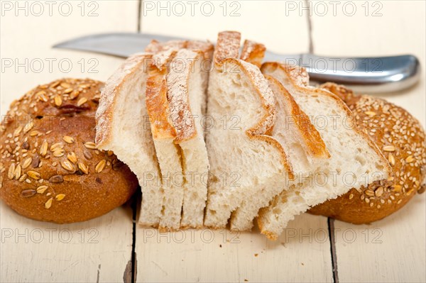 Fresh organic bread over rustic table macro closeup