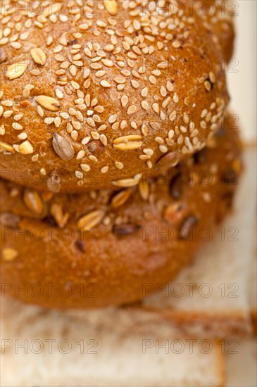 Fresh organic bread over rustic table macro closeup