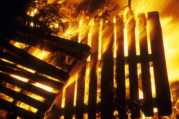 Wooden pallets in fire of huge bonfire during Christmas tree burning