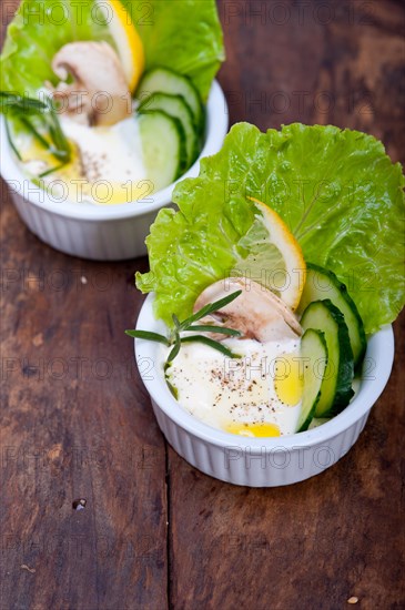 Fresh organic garlic cheese dip salad on a rustic table