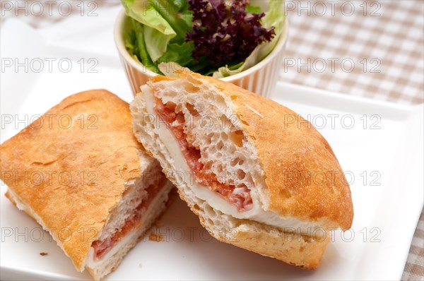 Italian ciabatta panini sandwich with parma ham and tomato