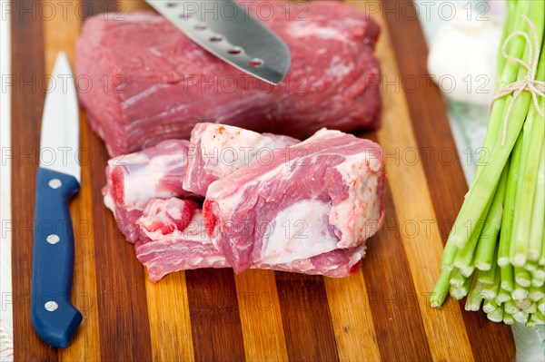 Raw beef and pork ribs with asparagus and herbs ready to cook