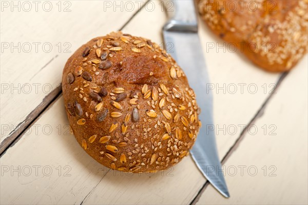 Fresh organic bread over rustic table macro closeup