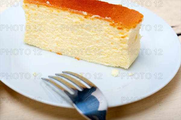 Fresh made cheese cake over white wood table