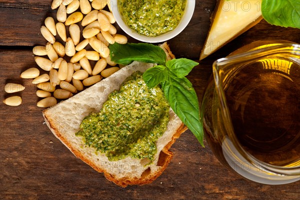 Italian basil pesto bruschetta ingredients over old wood macro