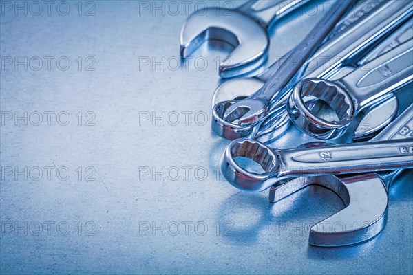 Vertical view of flat spanners and open-end spanners on a metallic background Repair concept