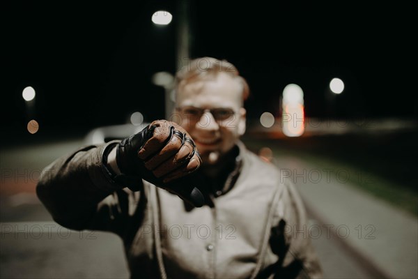 A motorcyclist shows his brown leather touring glove to the camera