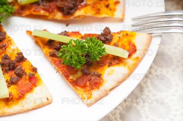 Fresh baked Turkish beef pizza with cucumber on top