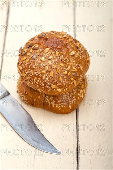 Fresh organic bread over rustic table macro closeup