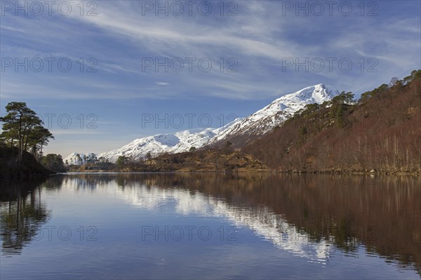 Caledonian Forest along Loch Affric and mountain Sgurr na Lapaich in winter