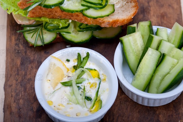 Fresh vegetarian sandwich with garlic cheese dip salad on rustic table