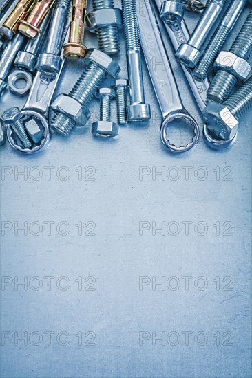 Composition of metal repair tools on metallic background vertical view design concept
