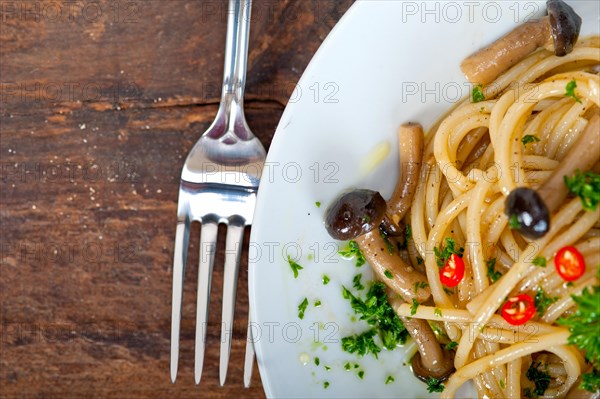 Italian pasta and mushroom sauce over rustic old wood