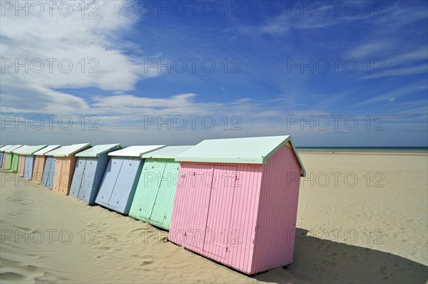 Row of colourful beach cabins in pastel colours along the North Sea at Berck