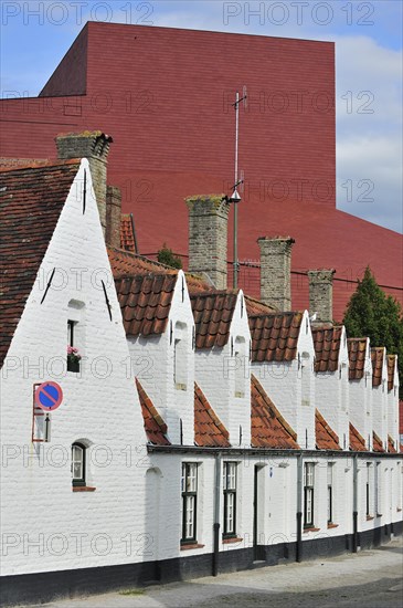 Alley with medieval almshouses and Concert Hall in Bruges