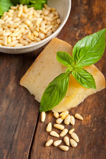 Italian basil pesto ingredients over old wood macro