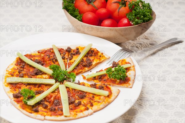 Fresh baked Turkish beef pizza with cucumber on top