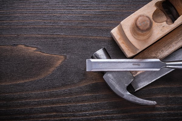 Copy space image of claw hammer razor plane and chisel on vintage wooden board building concept