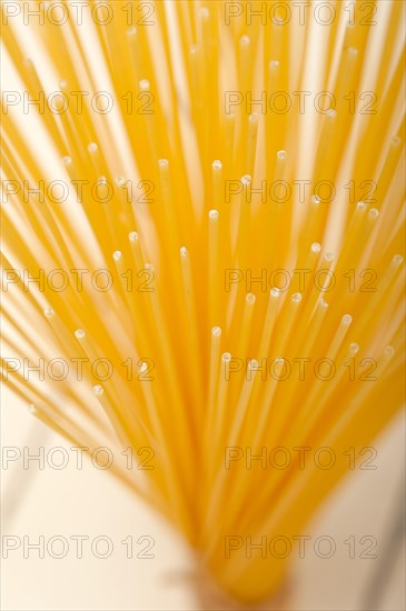 Italian pasta spaghetti tied with a rope on a rustic table