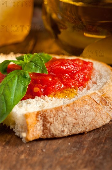 Italian fresh tomato and basil bruschetta with pecorino cheese over old wood