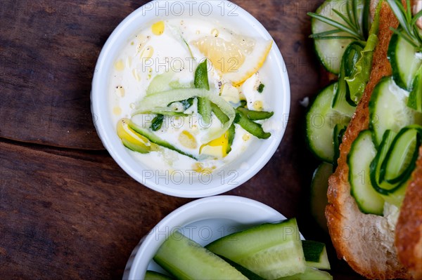 Fresh vegetarian sandwich with garlic cheese dip salad on rustic table