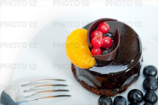 Chocolate cake and fresh fruit on top closeup macro