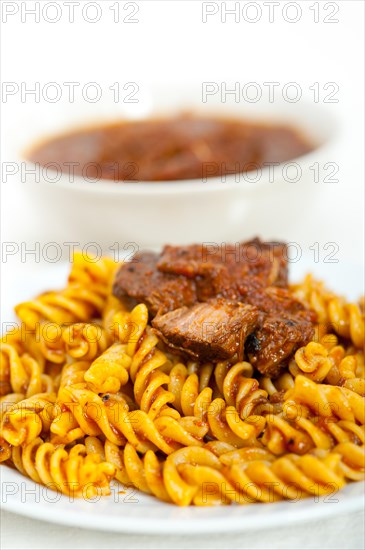 Fusilli pasta al dente with neapolitan style ragu meat sauce very different from bolognese style