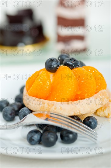 Fresh blueberry and tangerine orange cream cupcake homemade closeup macro