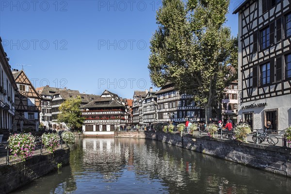 Half-timbered houses and restaurants along the River Ill in the Petite France quarter of the city Strasbourg