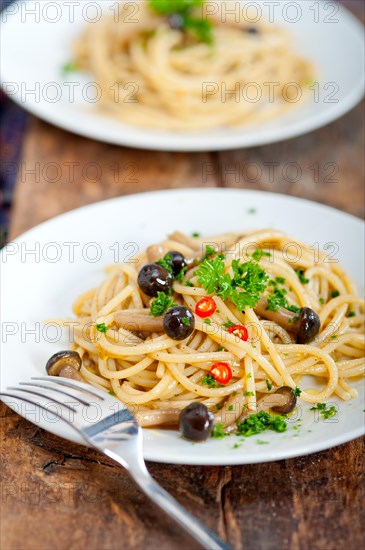 Italian pasta and mushroom sauce over rustic old wood