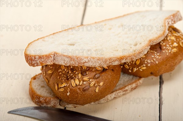 Fresh organic bread over rustic table macro closeup