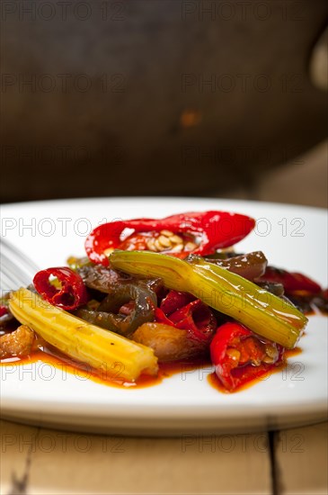 Fried chili pepper and vegetable on a iron wok pan