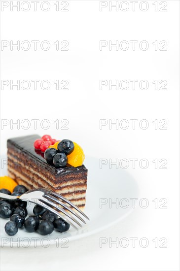 Chocolate cake and fresh fruit on top closeup macro