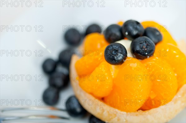 Fresh blueberry and tangerine orange cream cupcake homemade closeup macro