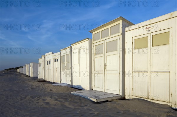 Row of white beach cabins along the North Sea coast at seaside resort Koksijde