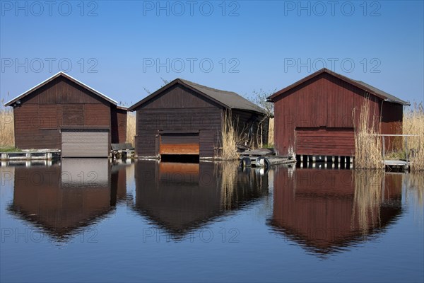 Wooden boat houses along Lake Neusiedel at Rust