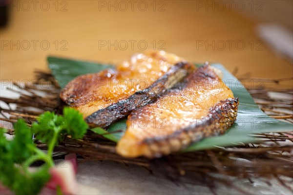 Japanese style teppanyaki roasted cod fish on palm leaf