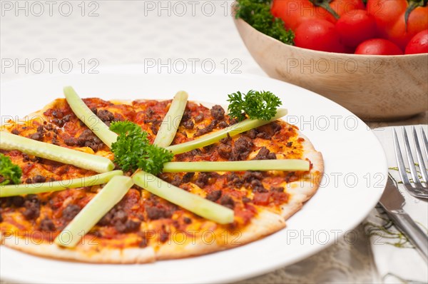 Fresh baked Turkish beef pizza with cucumber on top