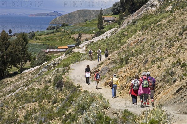 Tourists hiking on the island Isla del Sol in Lake Titicaca