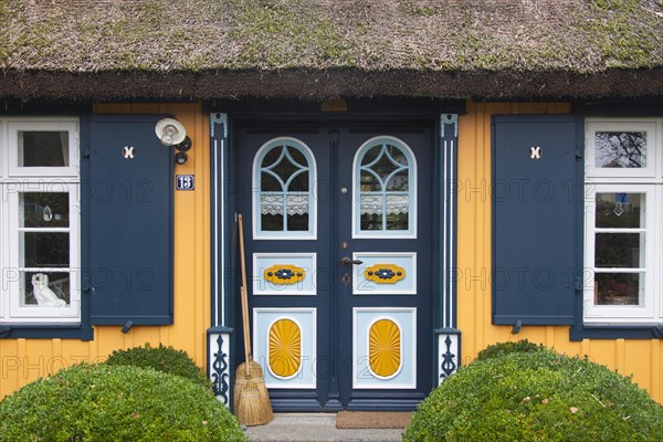Decorated entrance door of idyllic thatched cottage in the village Born auf dem Darss