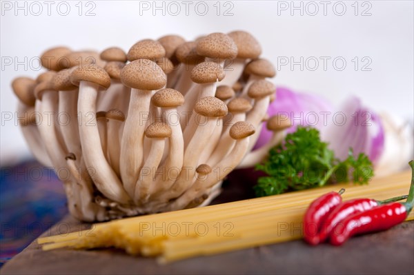 Italian pasta and mushroom sauce raw ingredients over rustic old wood