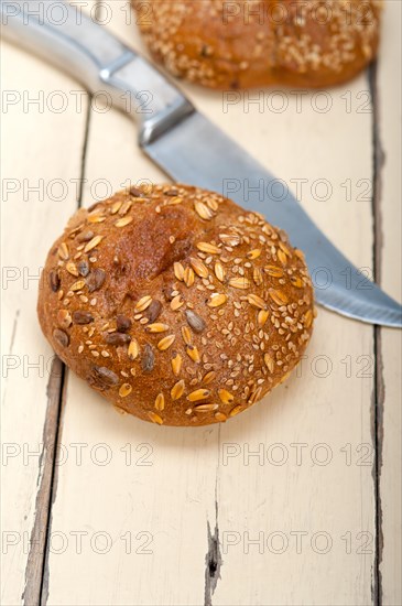 Fresh organic bread over rustic table macro closeup