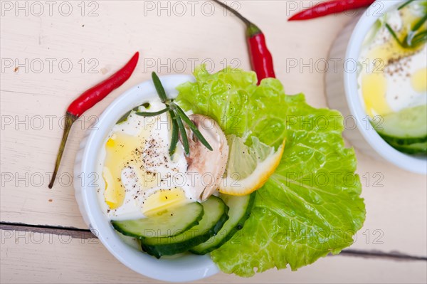 Fresh organic garlic cheese dip salad on a rustic table