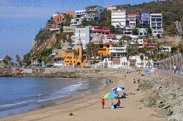 Tourists sunning on the beach along the Malecon