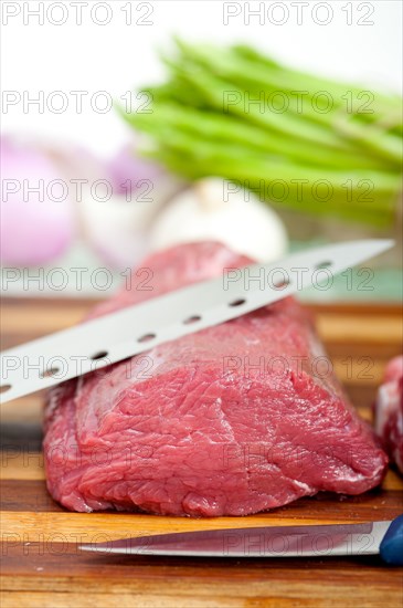 Raw beef and pork ribs with asparagus and herbs ready to cook