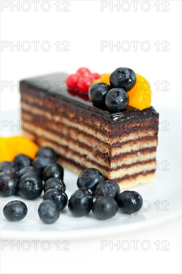 Chocolate cake and fresh fruit on top closeup macro