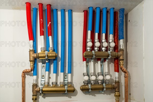 Domestic central heating system showing red tubes for hot water and blue pipes for cold water in the house